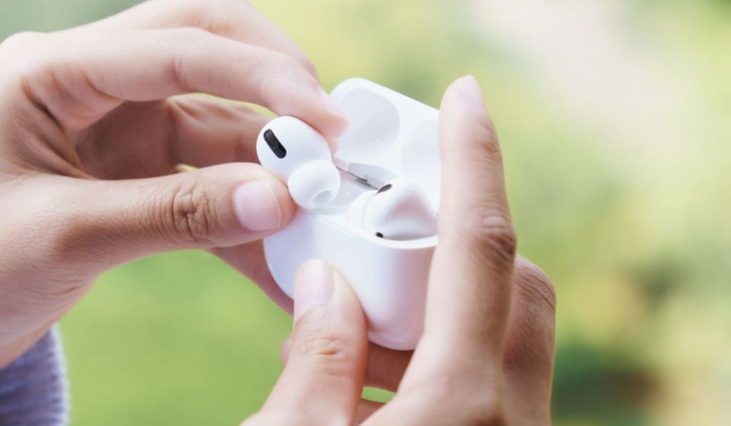 Earbuds in female hand