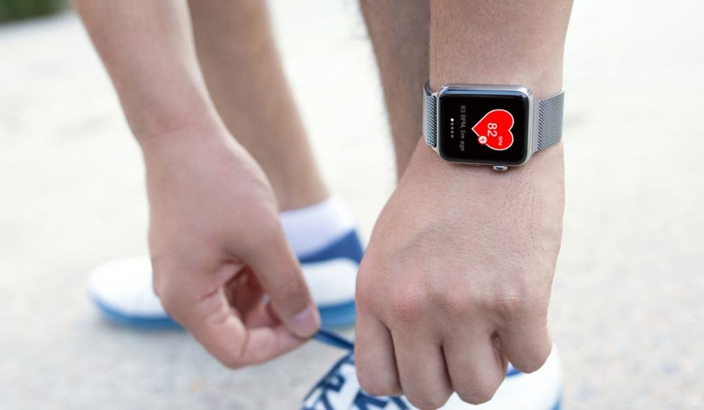 Athlete hand with watch and app health on the screen 