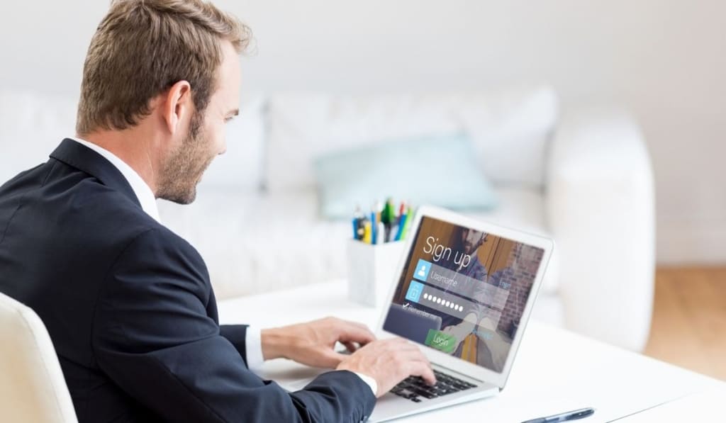 Businessman signing up on web page using laptop