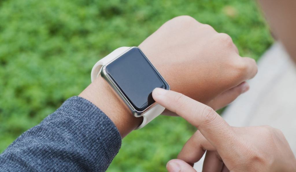 Closeup woman using hand touching on smart watch