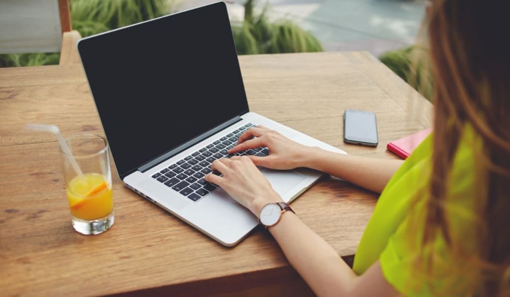 Creative female freelancer sitting front laptop computer with blank copy space screen for your information 