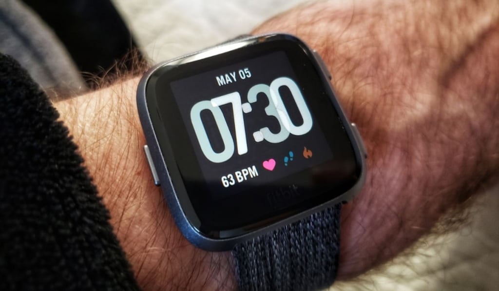 Fitbit Versa smartwatch on a man`s arm