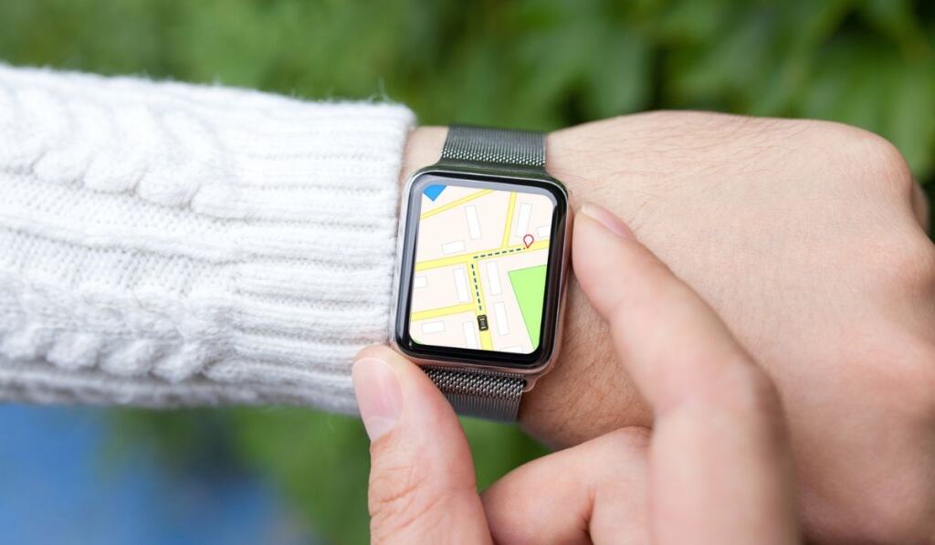 Man hand and smart watch with map in the screen