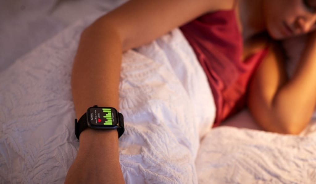 Woman Sleeping In Bed With Focus On Smart Watch She Is Wearing