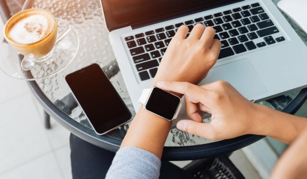 Woman using smart watch in coffee shop