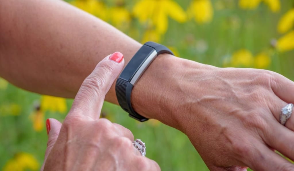 Woman using smartwatch to track activity