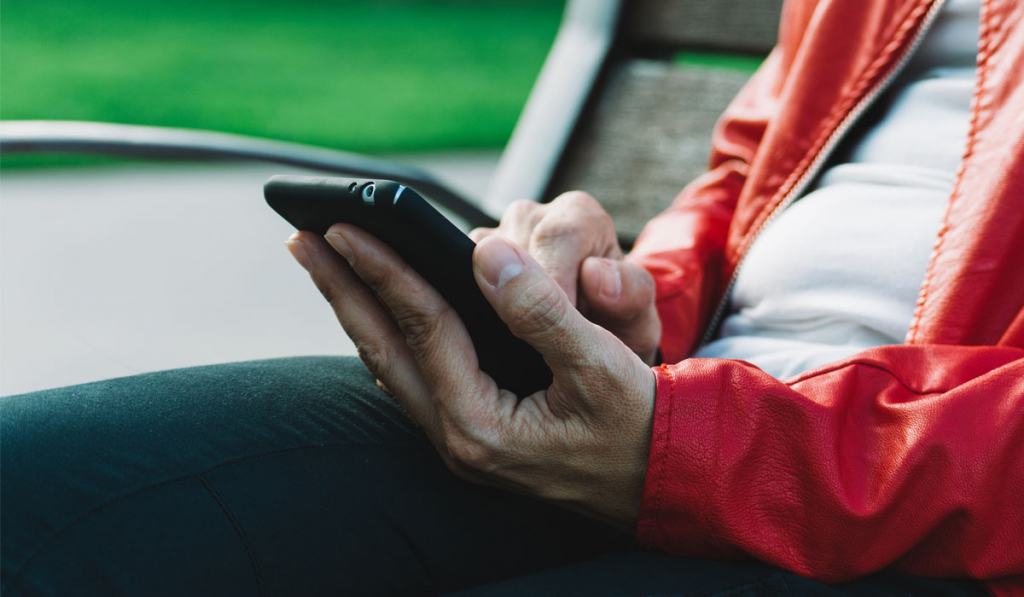 Woman holding a phone in the park