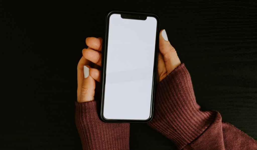 Woman's hands holding phone with blank screen