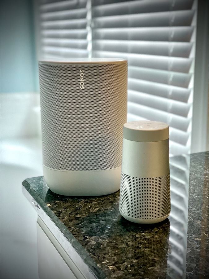 Bose SoundLink Revolve, a Refurbished Only Buy 4 Bose SoundLink Revolve speaker next to a taller Sonos Move on a granite counter
